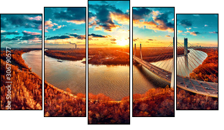 Beautiful panoramic aerial drone view to cable-stayed Siekierkowski Bridge over the Vistula river and Warsaw City skyscrapers, Poland in gold red autumn colors in November evening at sunset - Five-piece canvas, Pentaptych
